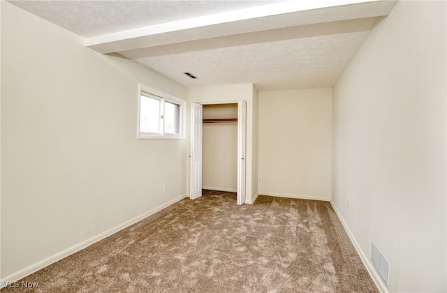 unfurnished bedroom with carpet flooring and a textured ceiling