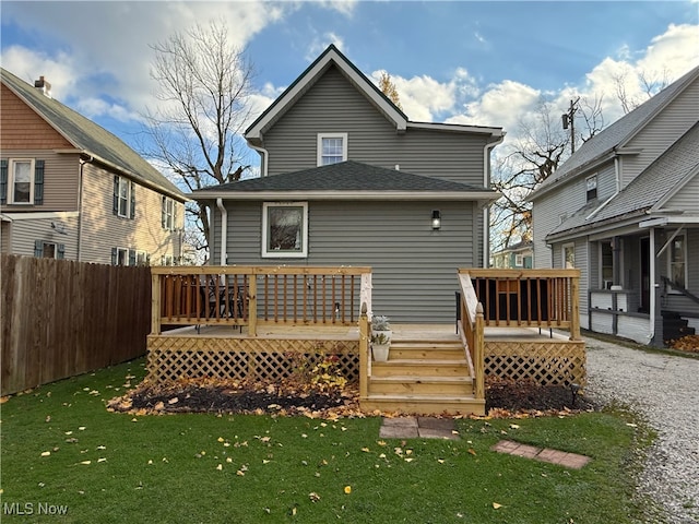 back of house with a lawn and a deck