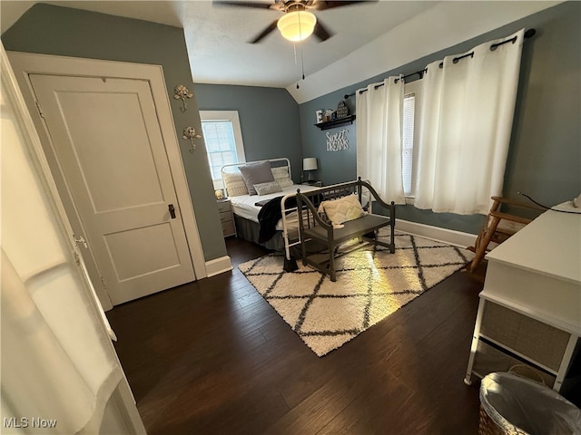 bedroom with dark hardwood / wood-style flooring, ceiling fan, and lofted ceiling