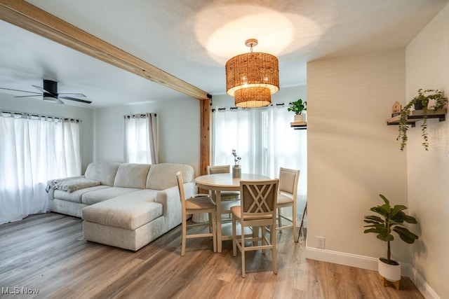 living room featuring hardwood / wood-style flooring, ceiling fan, and beamed ceiling