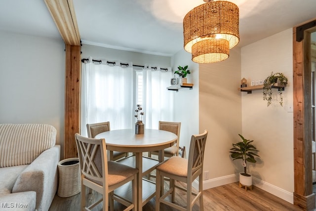 dining space with hardwood / wood-style floors