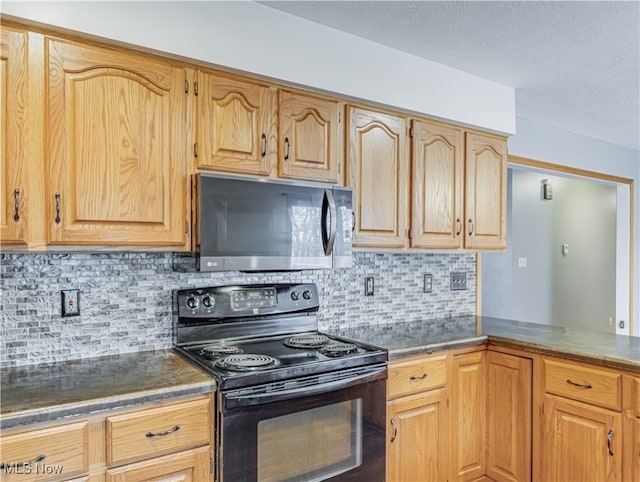 kitchen featuring backsplash and black / electric stove