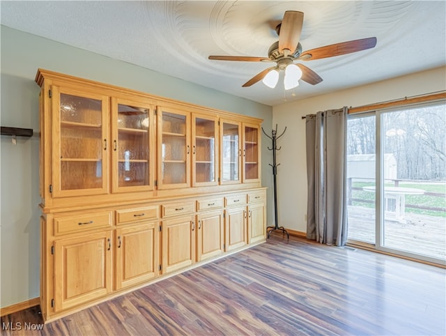 unfurnished dining area with ceiling fan and light hardwood / wood-style floors