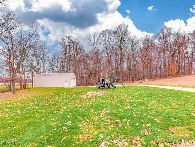 view of yard with a playground and an outbuilding