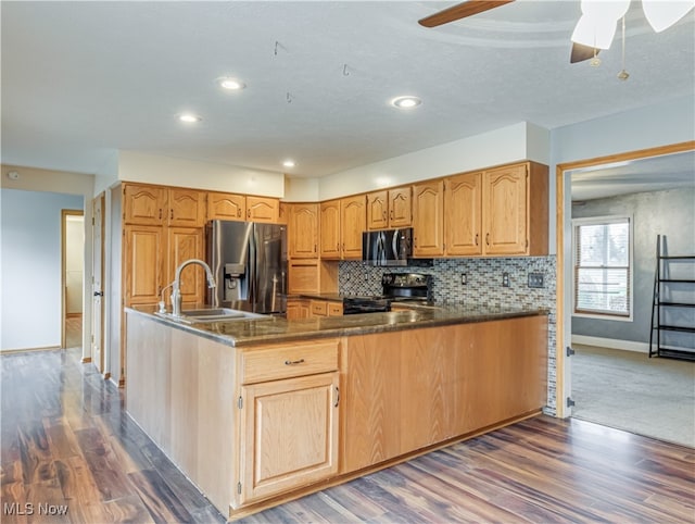 kitchen featuring black appliances, dark hardwood / wood-style flooring, and sink