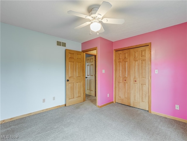 unfurnished bedroom featuring carpet, a closet, and ceiling fan