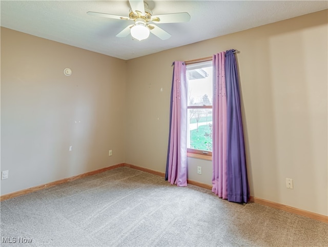 unfurnished room featuring ceiling fan and light carpet