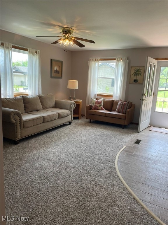 living room featuring carpet and ceiling fan