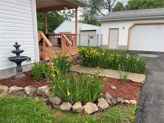 view of yard with a garage and a deck