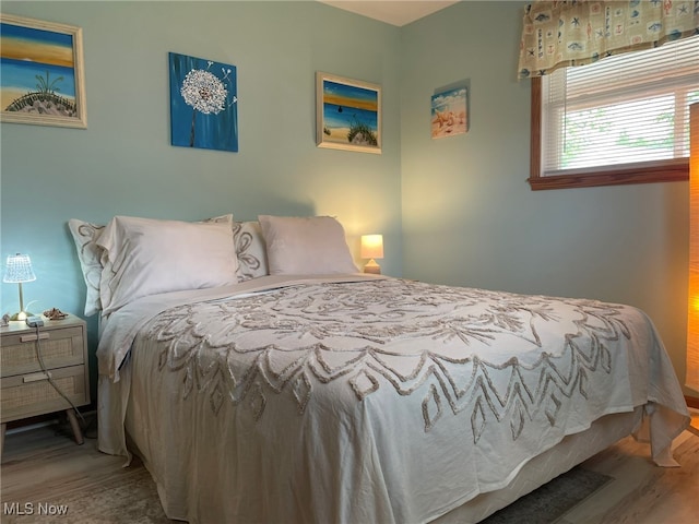 bedroom with wood-type flooring