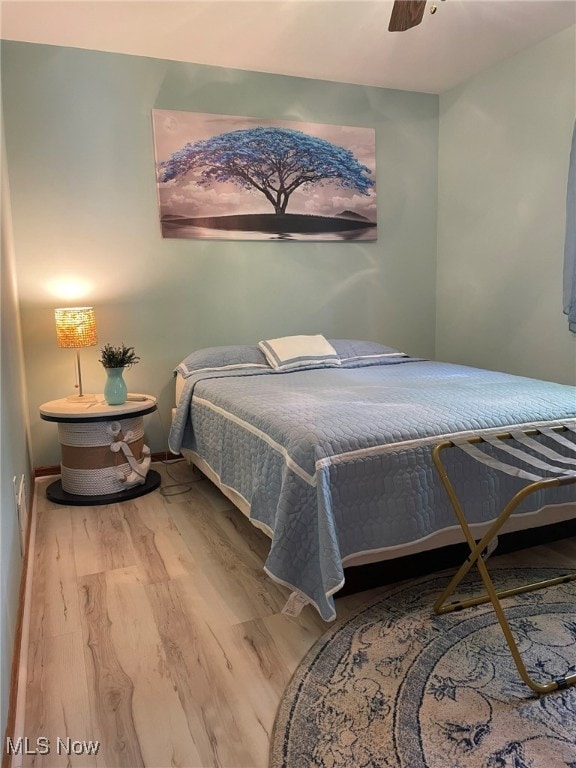 bedroom with hardwood / wood-style flooring and ceiling fan