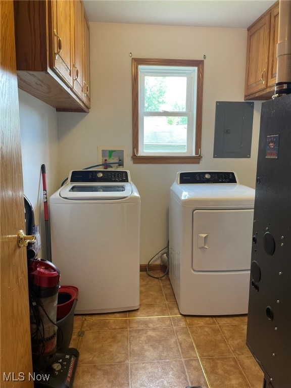 laundry area with cabinets, electric panel, light tile patterned flooring, and washing machine and clothes dryer