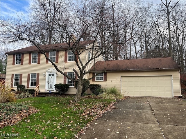 view of front of home with a front lawn and a garage