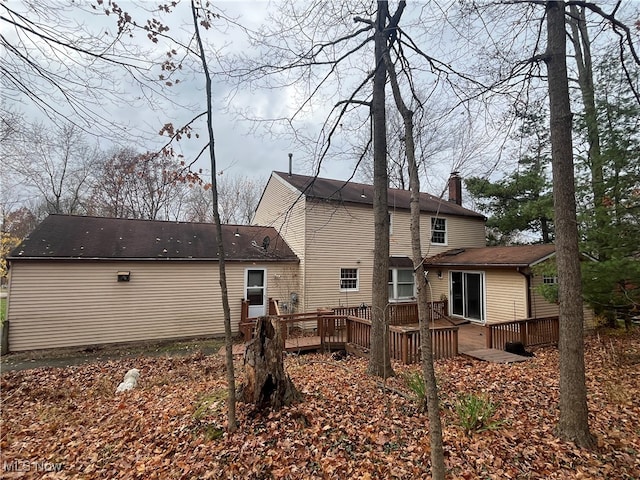 back of house with a wooden deck