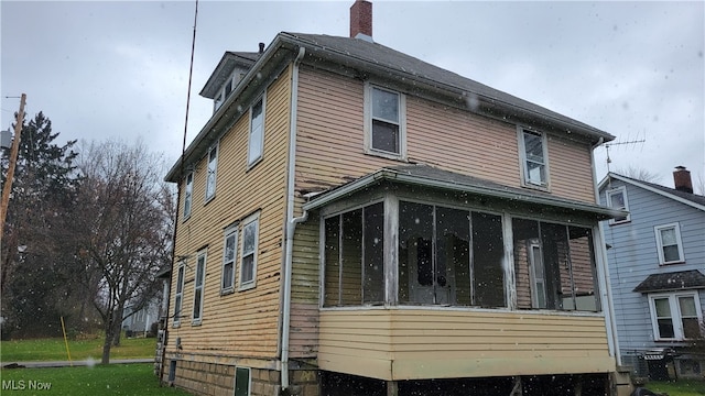 view of side of property with a sunroom