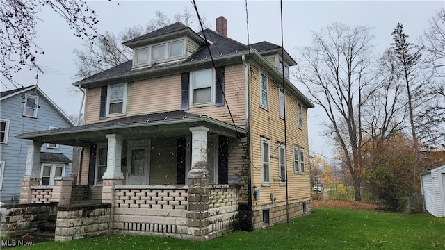 view of front of house with a front lawn and a porch