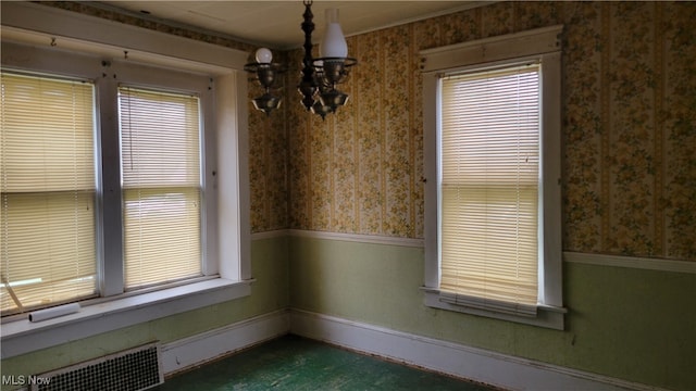 unfurnished dining area with an inviting chandelier