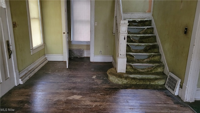 interior space with hardwood / wood-style flooring and a baseboard heating unit