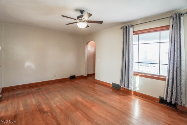 spare room with hardwood / wood-style floors and ceiling fan