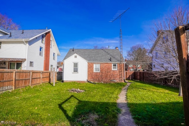 back of house featuring a yard