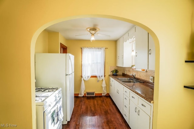 kitchen with white cabinetry, gas range gas stove, sink, ceiling fan, and dark wood-type flooring