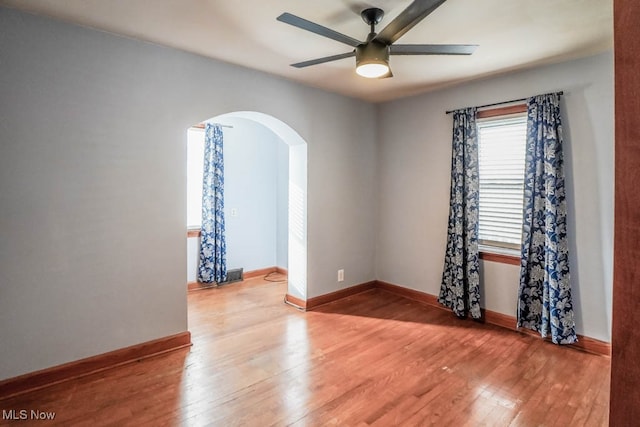 empty room with ceiling fan and light hardwood / wood-style floors