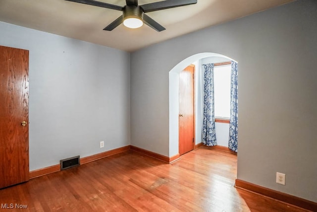 empty room featuring ceiling fan and light hardwood / wood-style flooring