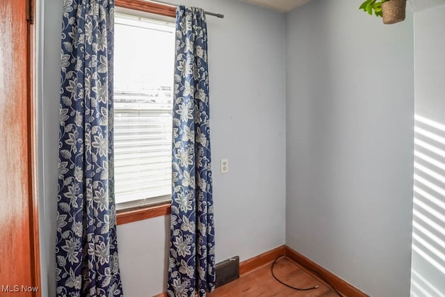 spare room with wood-type flooring