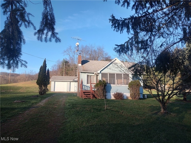 ranch-style home with an outbuilding and a front lawn