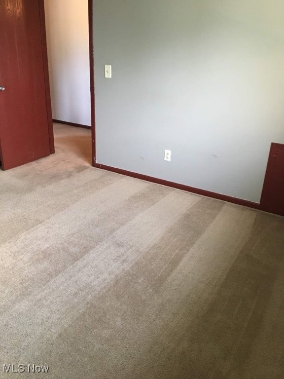 spare room with light carpet