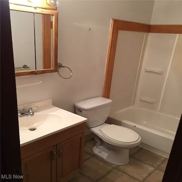 full bathroom featuring tile patterned floors, toilet, vanity, and bathing tub / shower combination