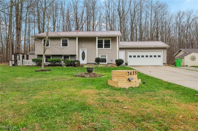 bi-level home featuring a garage and a front lawn