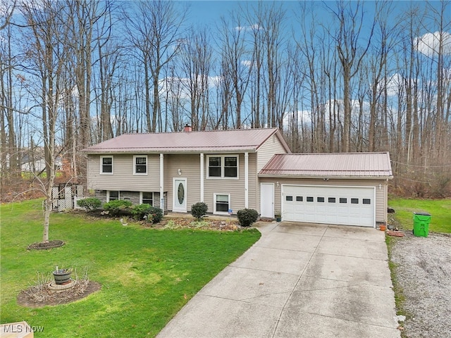 bi-level home featuring a garage and a front lawn