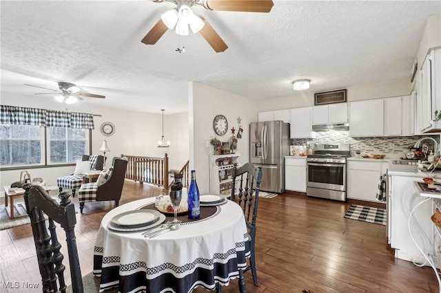 dining room with a textured ceiling, dark hardwood / wood-style flooring, ceiling fan, and sink