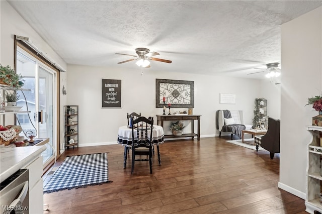 dining space with dark hardwood / wood-style flooring and a textured ceiling