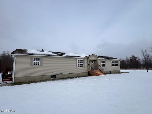 view of snow covered rear of property