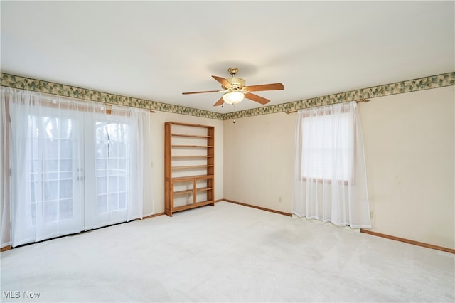 spare room featuring ceiling fan and carpet