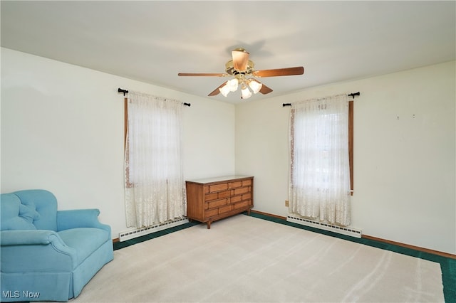 living area with ceiling fan, light colored carpet, and baseboard heating