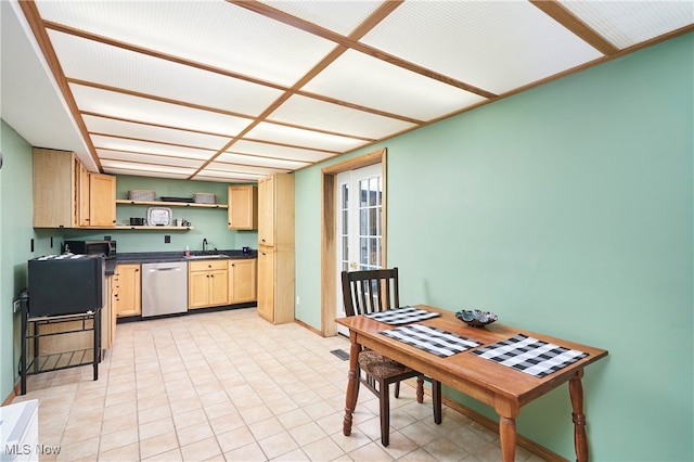 kitchen featuring dishwasher, light brown cabinetry, and sink