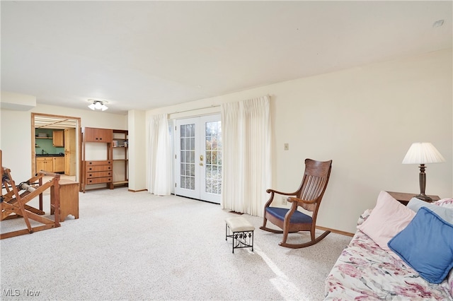 interior space with french doors and light colored carpet