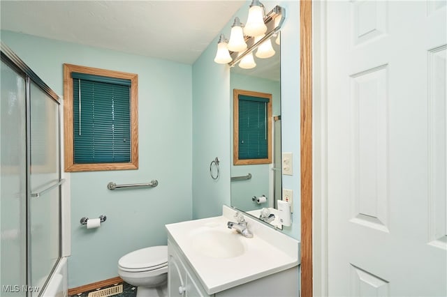 full bathroom featuring vanity, toilet, and combined bath / shower with glass door