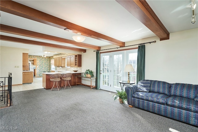 living room featuring light carpet and beamed ceiling