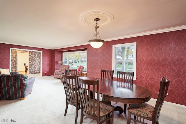 carpeted dining area featuring crown molding