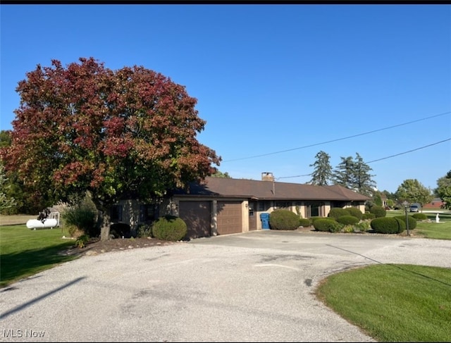 view of front of property with a garage and a front yard