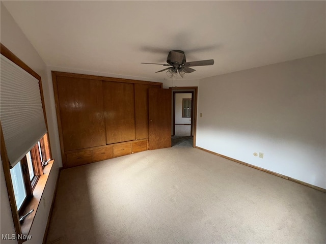 unfurnished bedroom featuring carpet and ceiling fan