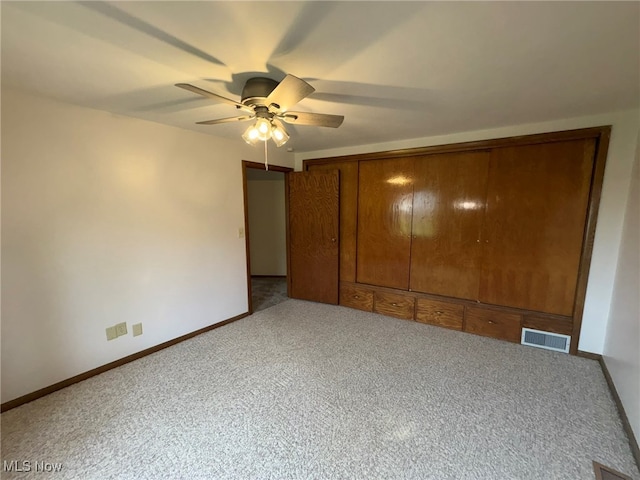 unfurnished bedroom featuring ceiling fan, light colored carpet, and a closet