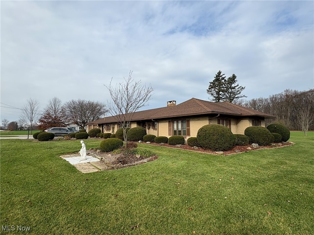 view of side of property with a lawn