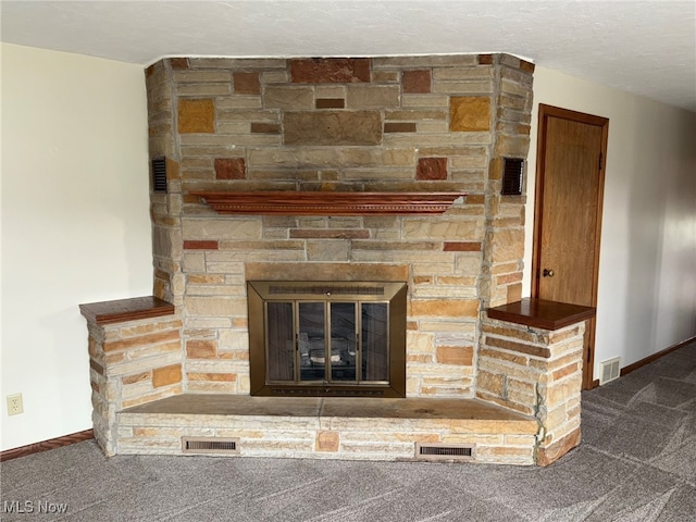 room details with carpet, a stone fireplace, and a textured ceiling