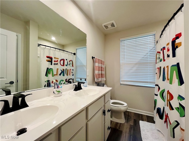 bathroom with a shower with shower curtain, vanity, wood-type flooring, and toilet