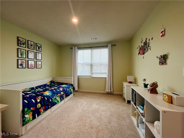 bedroom with a textured ceiling and light carpet